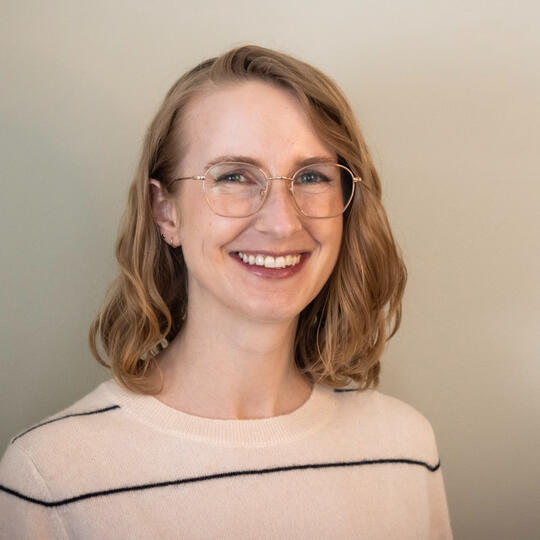 Liz Photo Liz, a white woman with a glasses, a white striped sweater, and shoulder-length blonde hair, is smiling.